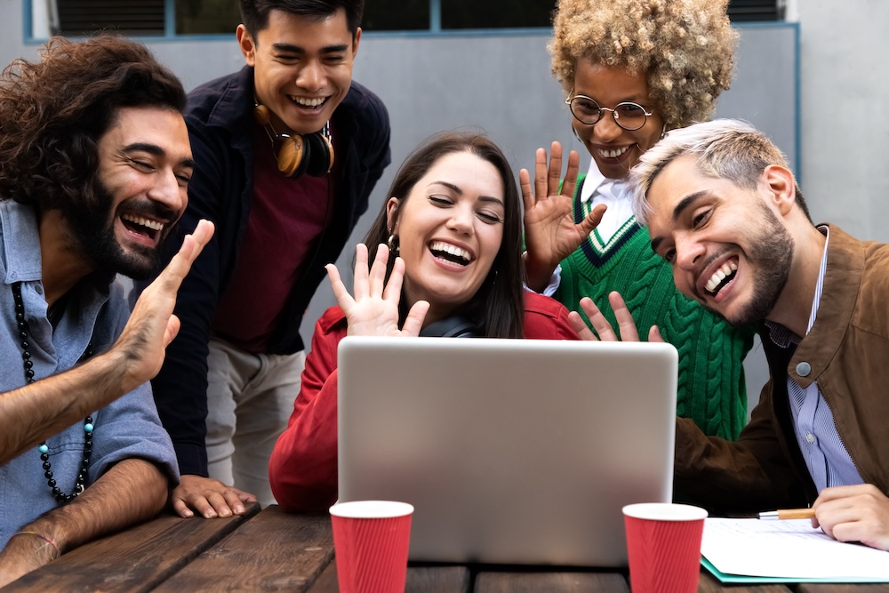 Group of friends smiling and creating an online presence on a call