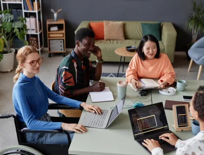 Young diverse team meeting at a table in the office