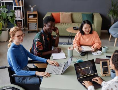 Young diverse team meeting at a table in the office