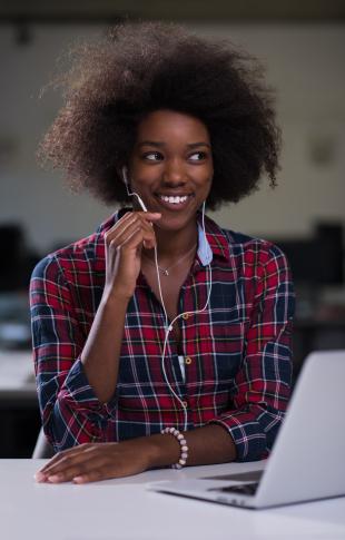 Black woman in modern office answering calls