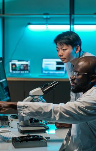 two male science students in a lab with their computer