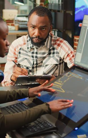 group of men together around a laptop