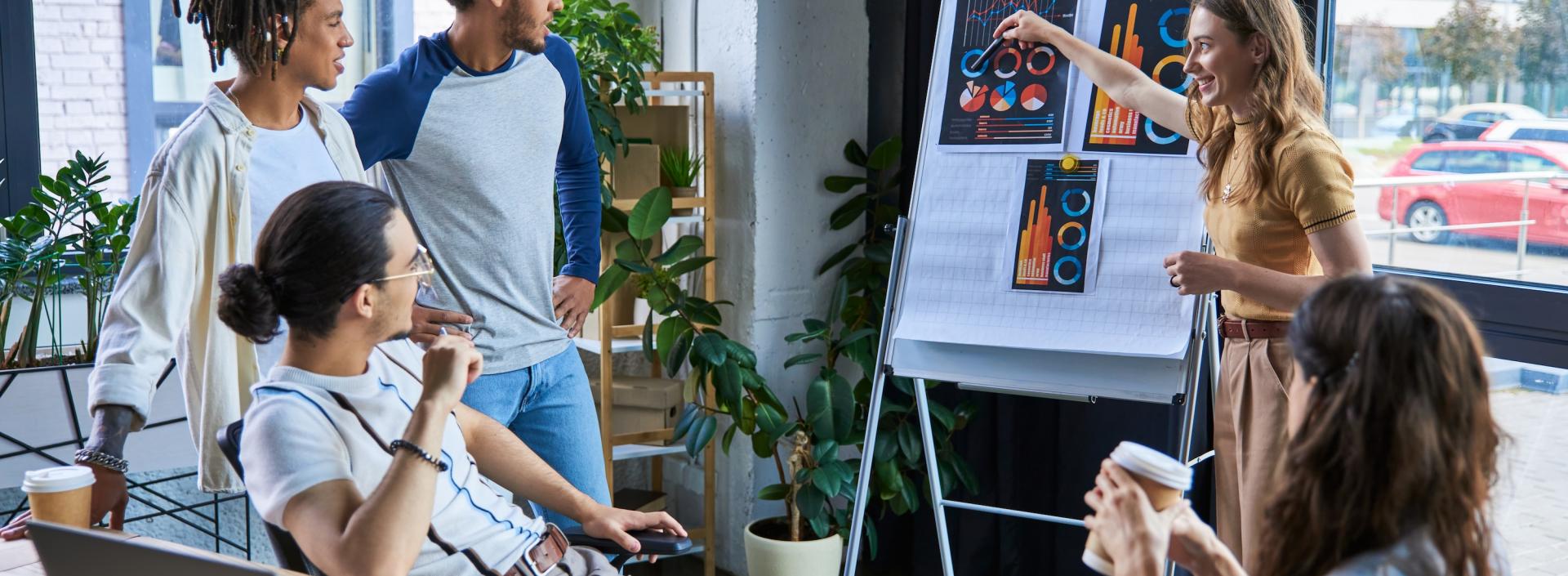 Business woman pointing at flip chart and discussing analytics